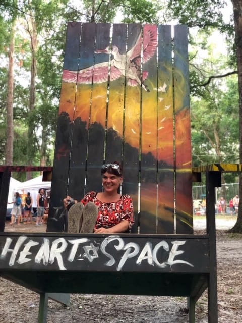 sitting on a giant adirondock chair at spirit of the suwannee music park in Florida along our road trip